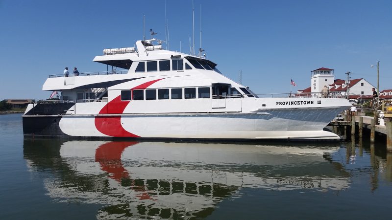 A ferry named "Provincetown III" sits parked at a wooden dock