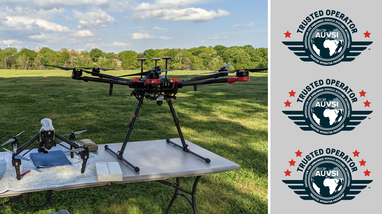 A small quadcopter and large hexacopter drone on a table, with a grass field and sunny sky behind. Overlaid are three AUVSI TOP training level logos.